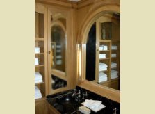 Pine panelled cloakroom with concealed lighting in hinged sections of mirror frame